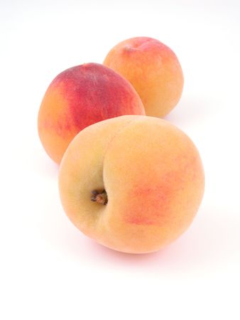 three peaches isolated on whiteの写真素材