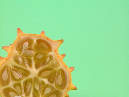 half of kiwano - close-ups on green backgroundの写真素材