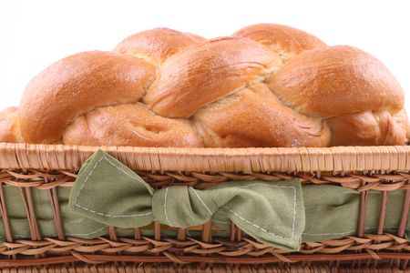 basket of challah bread isolated on white