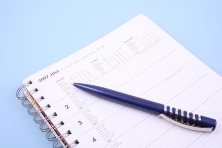 calendar with pen - July 2007 isolated on blueの写真素材