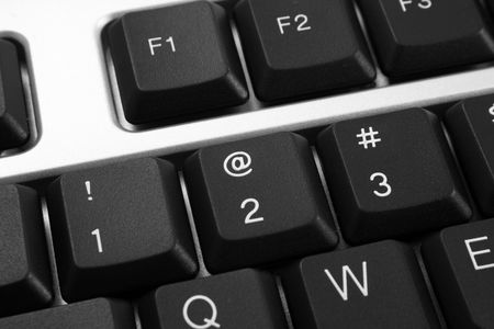 close-ups of @ - dark keyboard