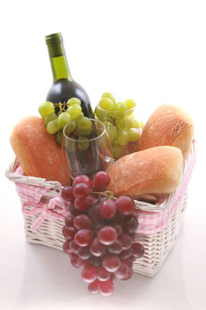 picnic basket full of food isolated on whiteの写真素材