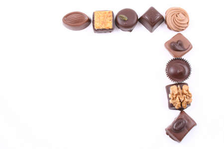frame of mixed chocolates isolated on whiteの写真素材