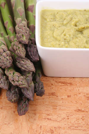 bowl of delicious asparagus soup and fresh asparagusの写真素材