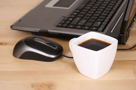 close-ups of laptop cup of coffee and mouse on deskの写真素材