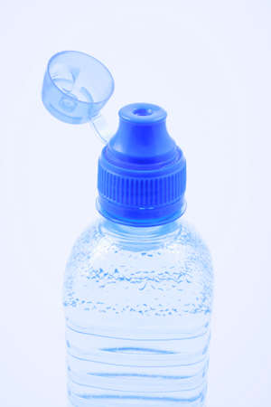 close-ups of bottle of mineral water on blue