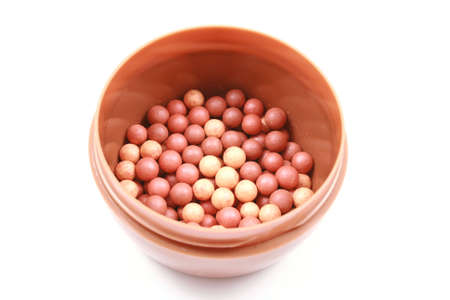 beauty treatment - box of bronzing pearls isolated on whiteの写真素材