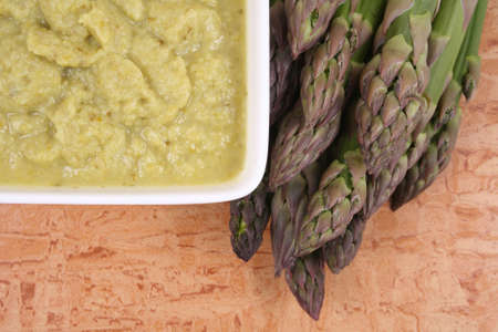 bowl of delicious asparagus soup and fresh asparagusの写真素材