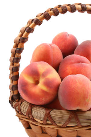 basket full of fresh peaches isolated on whiteの写真素材