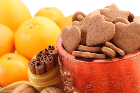 bowl of delicious gingerbreads and some fruitsの写真素材