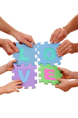 eight hands holding puzzle with love letters isolated on whiteの写真素材