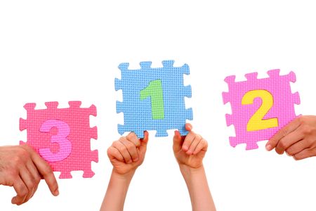 hands holding puzzle with number 1234 isolated on whiteの写真素材