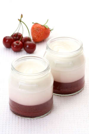 two glasses of yogurt with cherry - delicious breakfastの写真素材