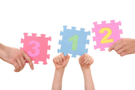 hands holding puzzle with number 1234 isolated on whiteの写真素材
