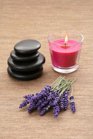bunch of lavender flowers candle and stonesの写真素材