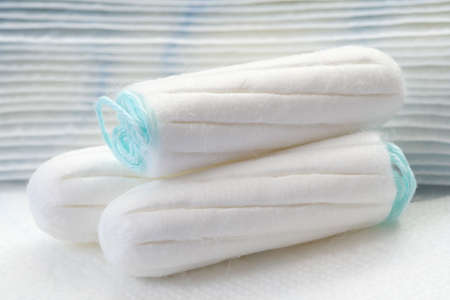 health care and medicine - white tampons on blue background