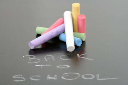 close-ups of blackboard and colorful chalksの写真素材