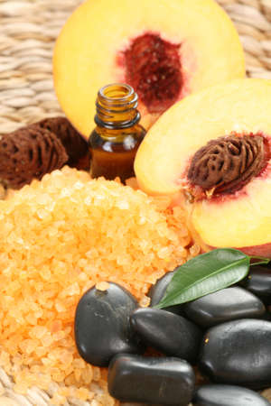 peaches bath with bath salt essential oil and fresh fruitsの写真素材
