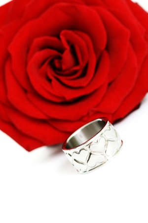ring with hearts and red rose isolated on whiteの写真素材