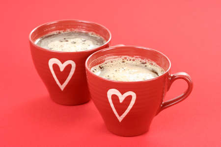 two cups of coffee on red background - food and drinkの写真素材