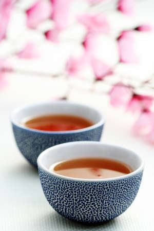 two cups of tea with pink flowers - food and drinkの写真素材