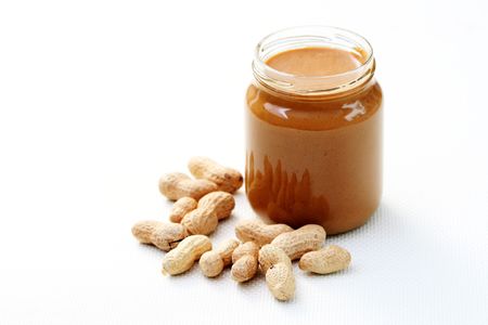 jar of peanut butter on white - food and drink