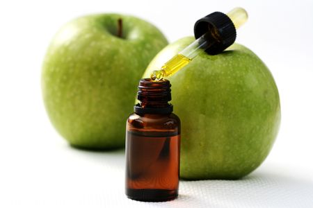 bottle of apple oil and fresh fruits - beauty treatmentの写真素材