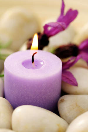 candle and lavender flowers in stones - relaxing timeの写真素材