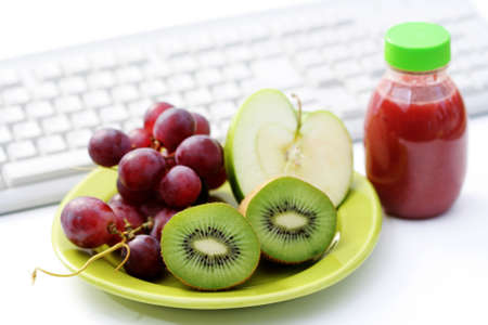 healthy snack in the office - plate of fresh fruitsの写真素材