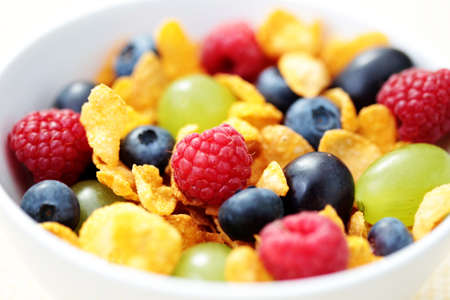 bowl full of corn flakes with fruits - diet and breakfast