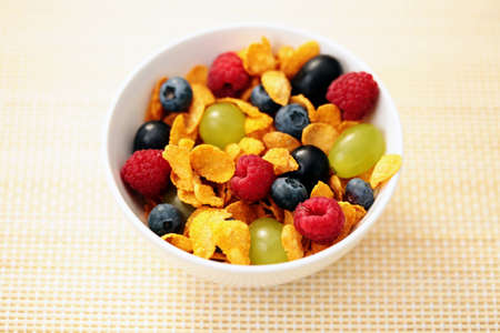 bowl full of corn flakes with fruits - diet and breakfastの写真素材
