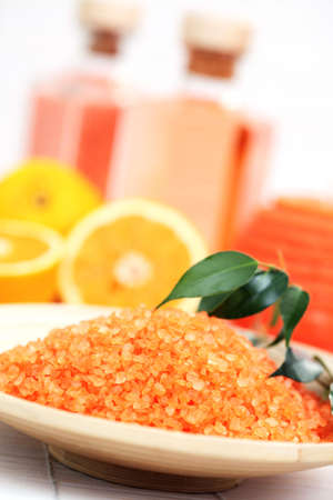 bowl of orange bath salt with fresh fruits - beauty treatmentの写真素材
