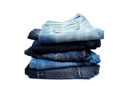 stack of blue jeans on white background