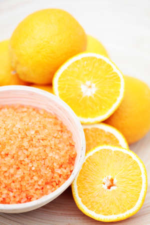 bowl of orange bath salt with fresh fruits - beauty treatmentの写真素材