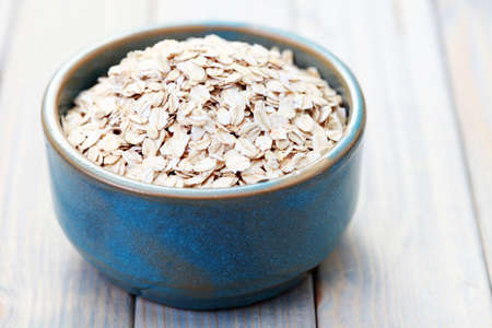 blue bowl full of oats - diet and brekafastの写真素材