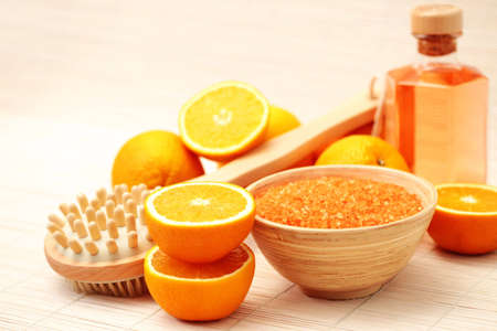 bowl of orange bath salt with fresh fruits - beauty treatmentの写真素材