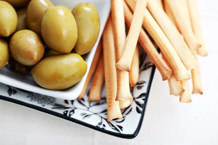 plate of grissini and green olives - food and drinkの写真素材