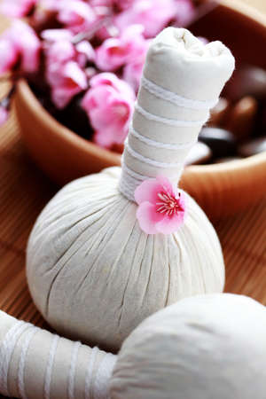 two massage stamps with bowl of stones - beauty treatmentの写真素材