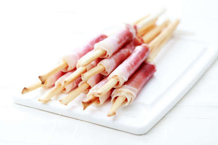 grissini with ham as a snack - food and drinkの写真素材