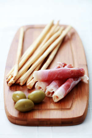 grissini with ham and olives as a snack - food and drinkの写真素材
