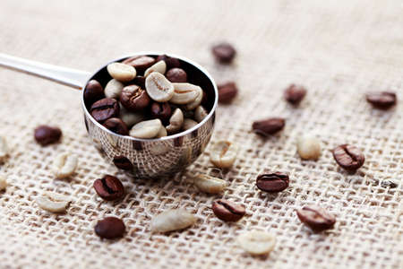 spoon of roasted and unroasted coffee beans - coffee timeの写真素材