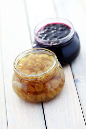 jar of gooseberry and black currant jam - food and drinkの写真素材