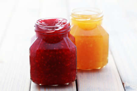 jar of orange and raspberry jam - food and drinkの写真素材