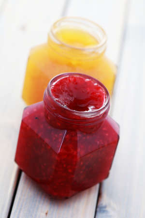 jar of orange and raspberry jam - food and drinkの写真素材