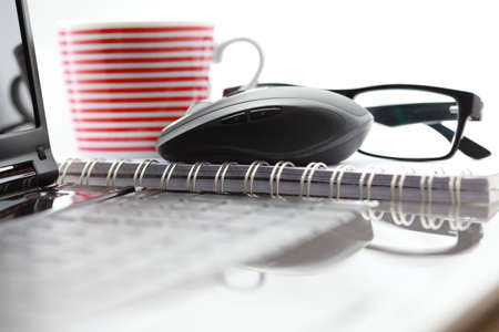 wireless mouse and laptop on desk - office lifeの写真素材