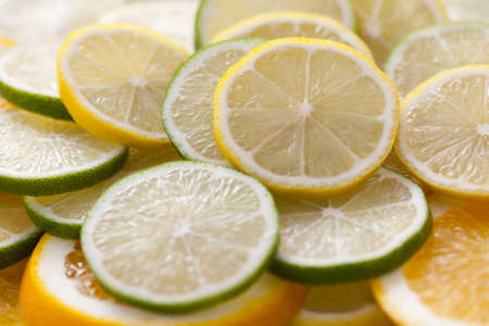 background of fresh sliced lemon and lime fruit - fruits and vegetablesの写真素材