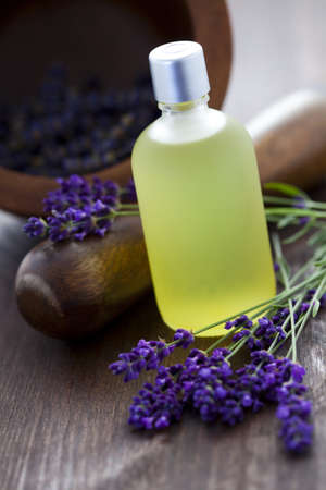 bottle of lavender massage oil with mortar and pestle - beauty treatmentの写真素材