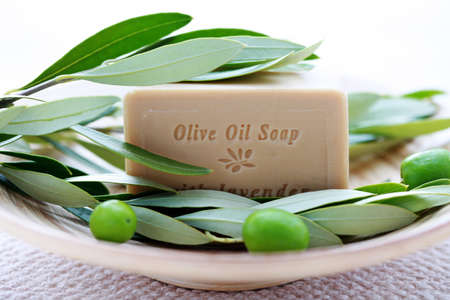 bar of organic olive oil soap with branch of olives - beauty treatmentの写真素材