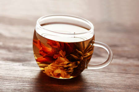 glass of white tea with beauty tea flower inside - tea timeの写真素材