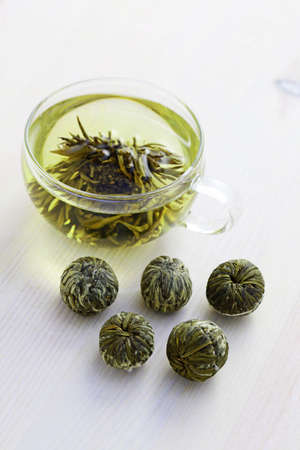 cup of green tea with flower inside - tea timeの写真素材